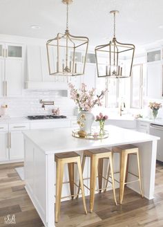 two stools sit at the center of a kitchen island