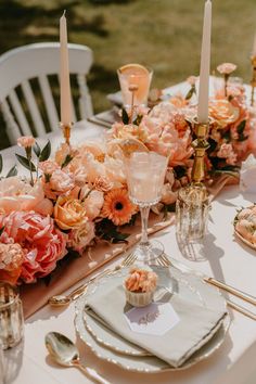 the table is set with flowers and candles