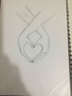 a pencil drawing of a hand holding a heart