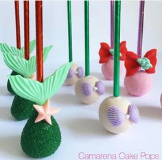 there are some cake pops decorated like little mermaids