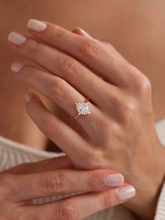 a woman's hand with a diamond ring on it