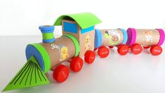 a wooden toy train with different colored wheels