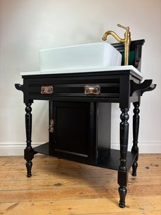 a sink and cabinet in a room with wooden floors, white walls and wood flooring