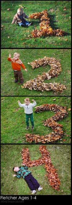 two children are standing in the grass with leaves on them and one child is holding his hands up