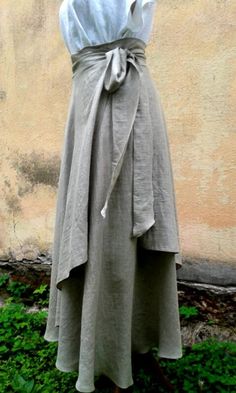 a dress on display in front of a wall with grass and ivy growing around it