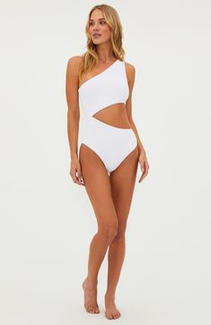 A sunny cutout defines this solid one-piece fashioned with a one-shoulder neck. One-shoulder neck Moderate back coverage Lined 82% polyester, 18% spandex Machine wash, tumble dry Made in the USA One Shoulder Beachwear Bodysuit For Beach Season, One-shoulder Beachwear Bodysuit For Beach Season, One-shoulder Bodysuit For Poolside And Beach Season, One Shoulder Beachwear Bodysuit For Vacation, One Shoulder Bodysuit For Poolside, One-shoulder Bodysuit For Poolside, White Off-shoulder Fitted Swimwear, White Fitted Off-shoulder Swimwear, Fitted Off-shoulder White Swimwear