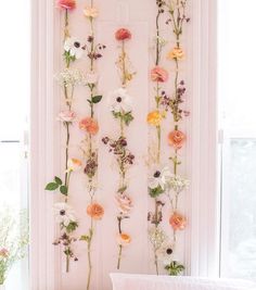 the flowers are hanging on the wall above the bed