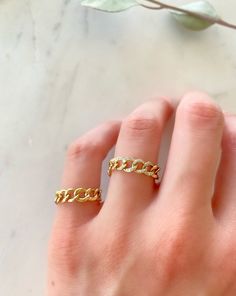 Dress up your everyday basics with this Cuban Chain Ring, expertly crafted in glowing 14K gold with the option of Diamonds. Add a couple of delicate fine rings to this beauty!! Your chain necklaces can now be paired with a sleek matching ring. This modern-luxe link band adds instant sophistication. Metal: 14K Yellow Gold (Stamped) Chain Width: 5 mm Stone: Diamonds Size Option: 6, 6.5, 7, 7.5, 8, 8.5 Adjustable Chain Gold Plated Rings, Gold Chain Jewelry With Open Ring Design, Gold Jewelry With Chain Detail In Open Ring Shape, Adjustable Chain Gold Plated Open Ring, Adjustable Gold Plated Open Chain Ring, Gold Adjustable Chain Ring Fine Jewelry, Gold Plated Adjustable Chain Ring, Gold Plated Open Chain Ring, Gold Plated Chain Rings As Gift