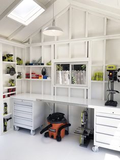 a workbench with lots of tools and supplies on the shelves in front of it