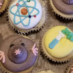 several cupcakes with different designs on them