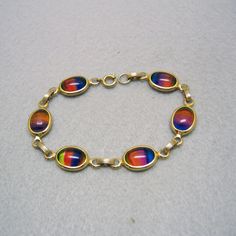 1960s Colorful Iris Glass Link Bracelet Vintage Multicolor Bracelets For Formal Occasions, Vintage Glass Bracelets For Jewelry Making, Rainbow Retro Jewelry For Gift, Retro Rainbow Colored Jewelry Gift, Retro Rainbow Jewelry Gift, Retro Multicolor Bracelet Jewelry, Retro Rainbow Jewelry For Gifts, Handmade Retro Rainbow Jewelry, Vintage Multicolor Oval Jewelry