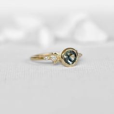 This unique design of modern boho 0.85c parti sapphire engagement ring is truly magical. Inspired by the moon shapes of its orbit cycle, it features a stunning round natural multi-colored parti sapphire captured in a raw bezel circle setting. The 14k yellow gold band is designed with two decorative side boho half moons and 4 side diamonds, making this beauty a one to remember! Perfect for the modern bohemian bride, this ring is sure to be a conversation starter. This ring is ready to ship in US Sapphire Birthstone Ring With Rose Cut Diamonds, Modern Sapphire Ring With Rose Cut Diamonds, Sapphire Ring With Rose Cut Diamonds, Round Sapphire Ring With Bezel Setting, Round Sapphire Ring With Rose Cut Diamonds, 14k Gold Celestial Sapphire Ring, Celestial Yellow Gold Sapphire Ring, Celestial Sapphire Round Ring, Celestial Style Sapphire Ring For Anniversary