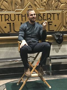 a man sitting in a chair with his arms crossed