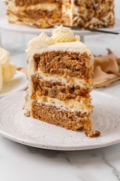 a slice of carrot cake on a plate with the rest of the cake in the background