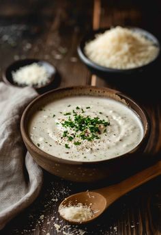 a bowl of soup with parmesan cheese on the side