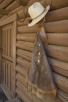 size: 12x8in Photographic Print: USA, Montana, Livingston, cowboy hat and chaps hanging on barn wall. by Merrill Images :