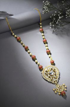 Discover elegance and sophistication with our Coral Stones & Pearls Harmony Necklace. This meticulously crafted piece is designed to elevate your style, offering a timeless beauty that complements any ensemble with grace and charm. Finish: Gold Finish Material: Brass, Corals, Pearls Color: Gold, White, Orange, Coral Size: One Size Closure Type: Box Lock Box Contains: 1 Necklace Elegant Long Temple Necklace For Festive Occasions, Elegant Kundan Temple Long Necklace, Elegant Long Kundan Necklace, Festive Long Bridal Necklace For Formal Occasions, Luxury Festive Necklaces With Stone Work, Elegant Kundan Necklace With Detachable Pendant For Festive Occasions, Elegant Pendant Bridal Necklace For Festive Occasions, Elegant Long Temple Necklace For Celebration, Elegant Temple Necklace For Reception