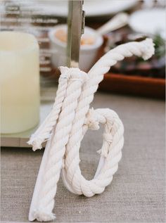 a white rope is tied to a metal stand