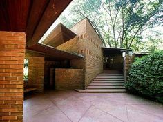 an outside view of a building with stairs and trees in the backgroung