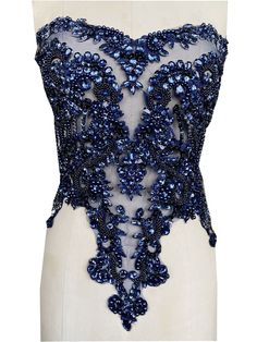 the back of a dress with blue beads on it