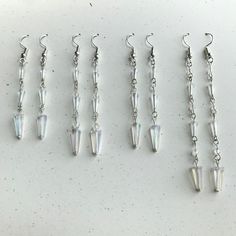 3 icicle beads - small, medium, and large, some with spacer beads and some without - hanging individually in a line from a fishhook earring.  Drop lengths vary from 1.75 inches to 2.75 inches. Fish Hook Earrings, Fish Hook, Spacer Beads, Jewelry Earrings Dangle, Etsy Earrings, Dangle Drop Earrings, Dangle Earrings, Etsy Accessories, A Line