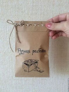 a hand holding a brown paper bag with an image of a piece of cake on it