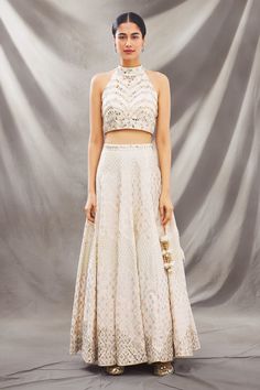 Ivory lehenga with all-over intricate floral embroidery. Comes with mirror embellished blouse and dupatta.
Component: 3
Embroidered
Neckline: Halter
Sleeve Length: Sleeveless
Fabric: Chanderi
Color: White
Cutout at the back
Embroidered dupatta
Closure: 
Blouse: Hook closure at the back
Lehenga: Drawstring with latkans - Aza Fashions Ivory Lehenga, Embroidered Lehenga, Embroidered Dupatta, Embellished Blouse, Luxury Sale, Embroidered Neckline, Set For Women, Festival Wear, Aza Fashion