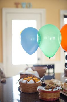 some balloons and bread on a table with other foods in the backgroung