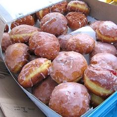 a box filled with lots of donuts covered in frosting