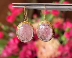 Pink Tourmaline Drop Earrings in 18k Yellow Gold, Statement Earrings, Bridal Earrings, Wedding Earrings These breathtaking Mid-Century earrings feature pink tourmaline gemstones in 18 karat yellow gold. Two (2) 12.11 carat tourmalines, each with a rose pink hue, are set in engraved bezels. Photogenic and fabulous! Shop More Drop Earrings. PRIMARY STONE Stone: Natural Pink Tourmaline Measurements: 18.93 mm x 14.24 mm x 5.30 mm = 12.11 ct (2) Weight: 24.22 ct Shape: Cabochon CHARACTERISTICS Measurements: 1.25 inch in length x 17.17 mm wide Era: Mid-Century 1940's-1960's Composition: 18 Karat Yellow Gold Total Gram Weight: 3.9 g -- ALL PIECES ARE SUBJECT TO PRIOR SALE DUE TO HAVING A RETAIL LOCATION. -- 10-DAY RETURN POLICY FREE SHIPPING TO THE CONTINENTAL UNITED STATES CONTACT OUR SHOP AT 61 Mid Century Earrings, Gold Statement Earrings, Earrings Wedding, Tourmaline Gemstone, Pink Tourmaline, Wedding Earrings, Bridal Earrings, Rose Pink, Pink Roses