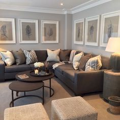 a living room filled with lots of furniture and pictures on the wall above it's coffee table