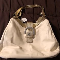 This Brand New All-Leather Shoulder Hobo Style Coach Bag Is Large And Has Three Separate Areas. First Section Has Large Buckled Snap Closure & Two Side Pockets, Middle Section Has Two Side Pockets And Zips At The Top. Third Section Has A Magnetic Snap Closure & A Zippered Side Pocket. Please Note There Is A Faint Stain As Shown In The Close Up. I Guess When I Purchased This, I Didn’t See The Mark Originally. It’s Been Stored In My Closet All This Time. Leather Is White & Light Gold. White Tote Shoulder Bag With Metal Hardware, Formal White Shoulder Bag With Metal Hardware, White Shoulder Bag With Metal Hardware For Office, White Formal Bag With Metal Hardware, Formal White Bag With Metal Hardware, White Hobo Bag For Formal Occasions, Classic White Hobo Bag For Formal Occasions, White Office Bag With Metal Hardware, Formal White Leather Shoulder Bag