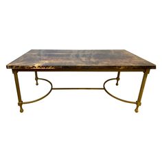 a table that is made out of metal and has a wooden top with gold legs