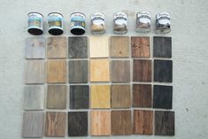 several different colors of wood are arranged on the floor next to each other with paint cans