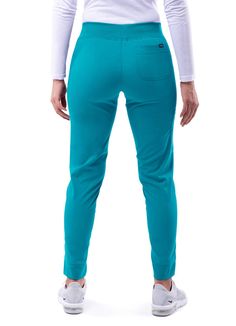 FEATURES: Super Soft Stretch Fabric Wrinkle-Resistant Odor Resistant Easy Care PRODUCT DESCRIPTION: This Ultimate Yoga Jogger by Adar is the perfect pant to take you from working in a chilly medical setting to running errands. It is in a league of its own with super soft stretch fabric, order/wrinkle-resistant fabric, and a duel hem. Our duel hem features a trouser hem in the front and adds a pinch of style with a classic jogger fit hem in the back. These comfortable scrub pants sit right below Medical Gifts, Surgical Hats, Perfect Pant, Fashion Mask, Scrub Pants, Basic Style, Teal Blue, Jogger Pants, Running Errands