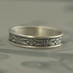 Mens Wedding Ring Silver Romance with an Edge Band Silver Mens Ring Silver Wedding Band Mens Promise Ring Womens Wedding Band for Her This is the wider version of our very popular Romance design, which can be found here: https://www.etsy.com/listing/96317363 Both can be purchased together as a set here: https://www.etsy.com/listing/615866348 The wider option is created from the same pre-patterned silver stock. We then expertly join an 18 gauge/1mm full round silver stock to either side for a fin Masculine Wedding Rings, Rings Aesthetic Men, Wedding Rings Aesthetic, Masculine Wedding, Mens Promise Ring, Wedding Rings Silver, Wedding Ring Silver, Silver Mens Ring, Mens Wedding Ring