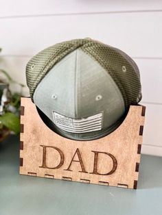 a wooden sign with a baseball cap on it that says,'dad's day