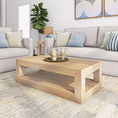 a living room with two couches, a coffee table and a rug on the floor