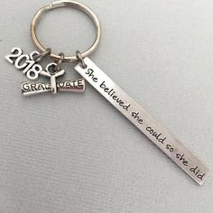 a keychain with the words great state and a tree on it is shown