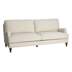 a white couch sitting on top of a wooden frame