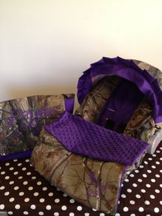 two purple bags sitting on top of a polka dot table