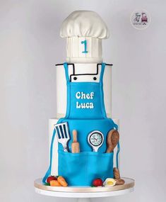 a chef's cake is displayed on a white pedestal with the words chef luca