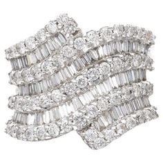 a white gold and diamond ring with three rows of baguetts in the middle