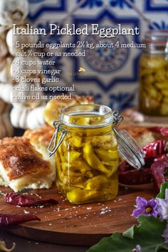 an italian pickled eggplant in a jar on a cutting board with other ingredients