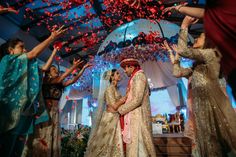 the bride and groom are surrounded by confetti