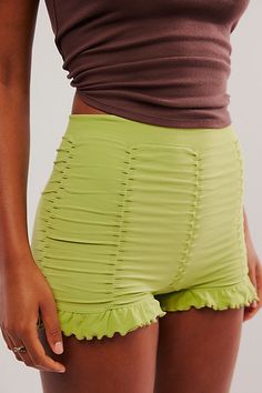 Stretchy seamless boy shorts with vertical ruched detailing all around with ruffles around bottom opening. | Ruched Seamless Shorts by Intimately at Free People in Green, Size: M/L Flirty Bottoms With Built-in Shorts And Stretch, Summer Flirty Ruched Bottoms, Short Stretch Ruffle Bottoms, Stretch Ruffled Short Bottoms, Stretch Ruffled Shorts For Loungewear, Stretch Ruffle Shorts For Loungewear, Flirty Green Summer Bottoms, Summer Seamless High-waisted Shorts, Flirty Green Bottoms For Summer