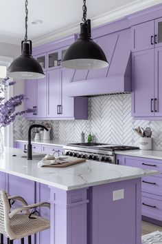 a kitchen with purple cabinets and marble counter tops, two pendant lights over the island