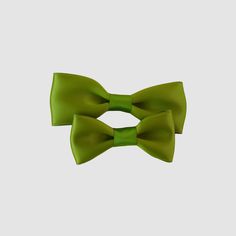 Dress to impress with our satin bow-tie! Available in 4 sizes, our bow-ties are perfect for newborns to men. With a wide range of 2024 fall and winter trending colors, they're perfect for weddings, holiday photoshoots, and any special occasion. Just slide clip over the top button and you are ready to go! • Satin ribbon• Bow-tie size • XS-0-6mos • Small 6mos.-4yrs. • Medium 4-12yrs • Large teen/adult• Handmade in the USA• Small women-owned business *Please note that bows are handcrafted and may vary slightly in size and look. Measurements are approximate. **NEVER leave children unattended or sleeping while wearing ANY hair accessories from Your Final Touch. Products may contain parts that can pose a choking hazard or strangulation. Solid Color Bow Tie For Party, Elegant Green Tie With Satin Bow, Party Suit And Tie Accessories With Satin Bow, Adjustable Green Bow Tie For Formal Occasions, Adjustable Green Ties For Party, Satin Bow Tie As Gift, Classic Green Tie With Satin Bow, Green Adjustable Tie For Party, Adjustable Green Tie For Party