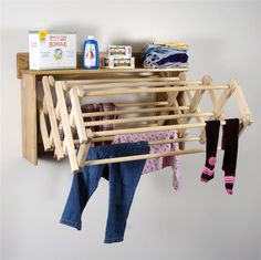 a clothes rack with baby's clothing hanging on it and two pairs of socks