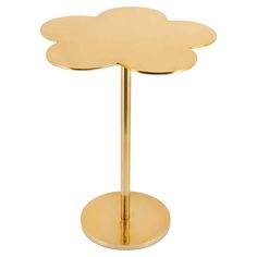 a gold metal table with a flower on the top and a circular base in the middle